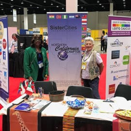 Two women representing NorCal at a convention booth.