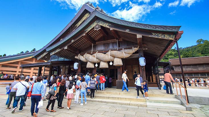 A Santa Clara youth group visiting Izumo, Japan, standing in front of a shrine.