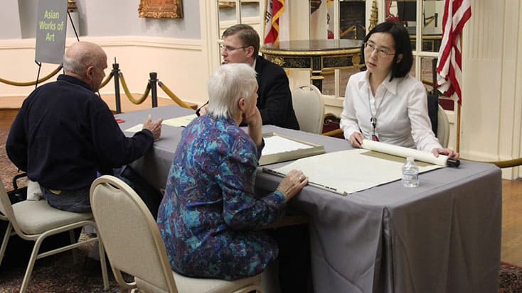 A group of people participating in the Bonhams Antique Valuation Event.