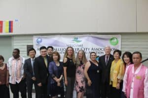 A group of people standing in front of a banner at annual Vallejo Sister City Association banquet