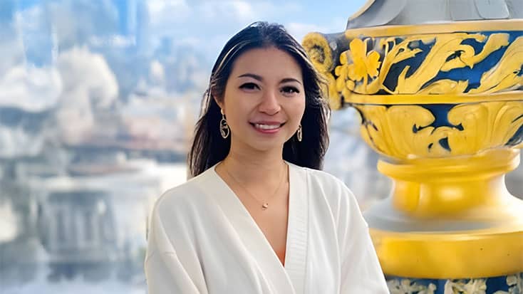 Anita Huang standing next to an ornate yellow and blue column.