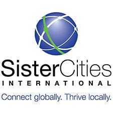 Sister Cities International logo with a blue globe and green line, tagline reads "Connect globally. Thrive locally.